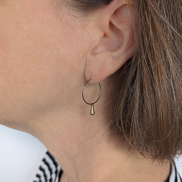 Titanium hoops with brass teardrop charms